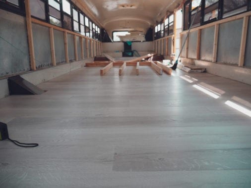 Laying floors in our skoolie was the first big project we go to do. | sincewewokeup.com | Since We Woke Up
