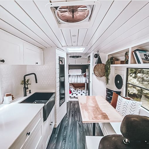 Today we're featuring Our Van Quest - a clean and bright white skoolie conversion that has everything a family of four needs travel in style! | Since We Woke Up | www.sincewewokeup.com